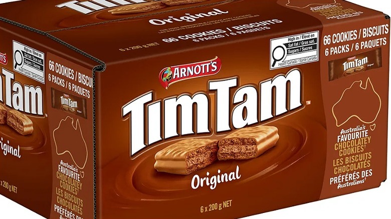 a box of Tim Tams from the side, with a photo of a biscuit snapped in half