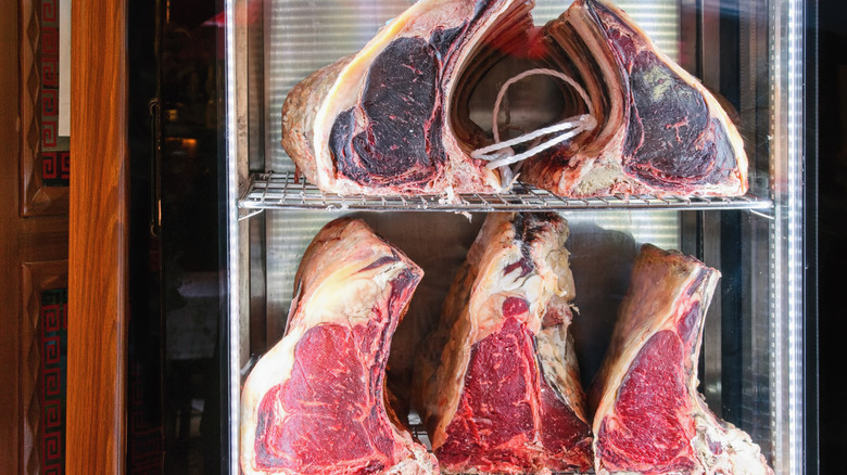 Racks of steak displayed in a butcher's window
