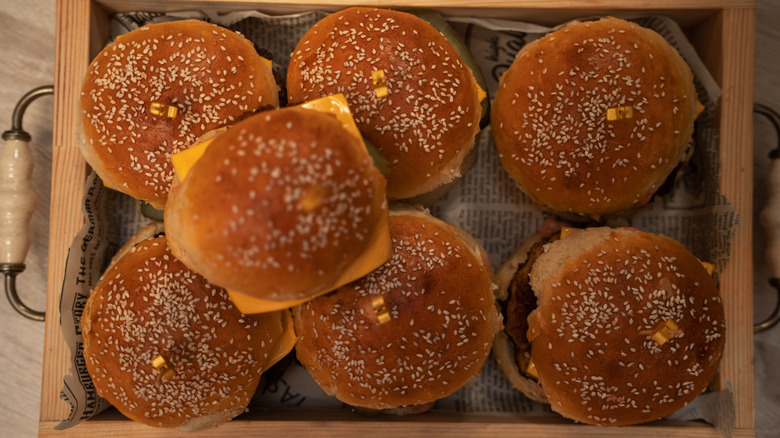 An overhead view of a tray of cheeseburgers