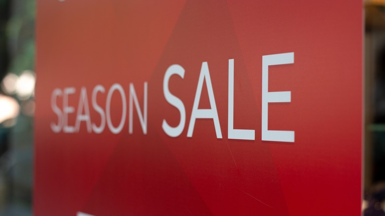 The words "Season Sale" are displayed on a red display board