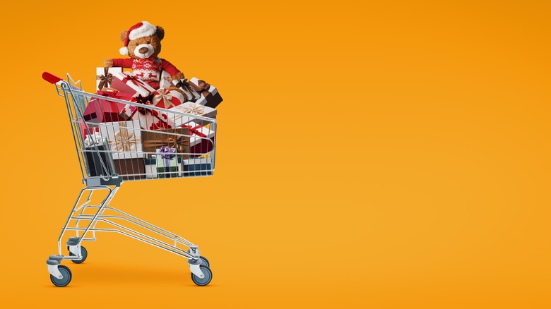 A supermarket shopping cart full of gifts, against an orange background