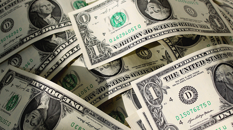 Many American dollar bills piled together