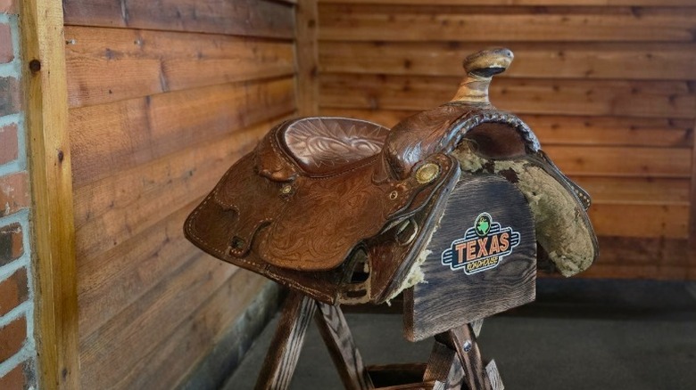 Close up of the Texas Roadhouse birthday saddle against a wooden background