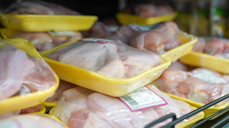 Various packaged chicken cuts on a grocery store shelf