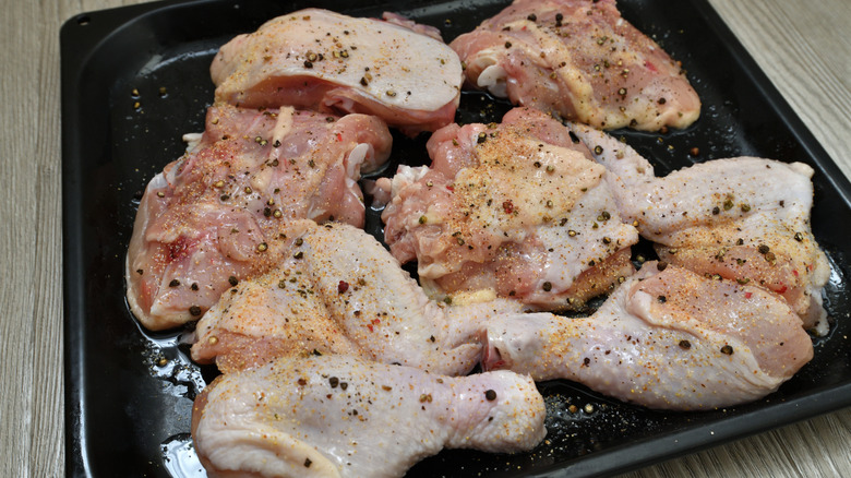 Chicken thighs and drumsticks overcrowded onto a small pan