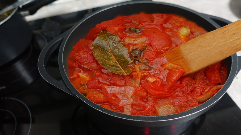 Tomato sauce simmering in a cast iron Dutch oven