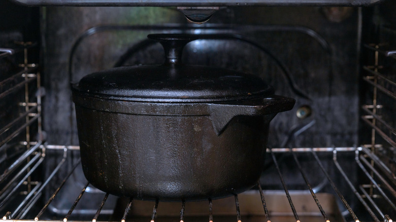 A cast iron Dutch oven inside an oven
