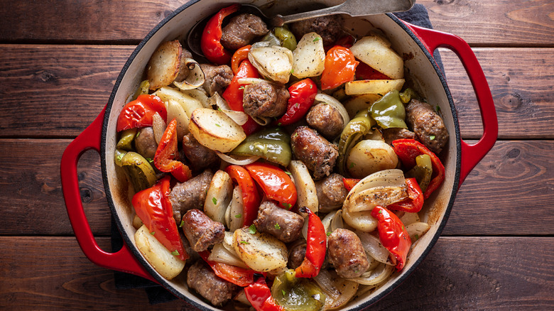 A Dutch oven packed with food on a wooden table