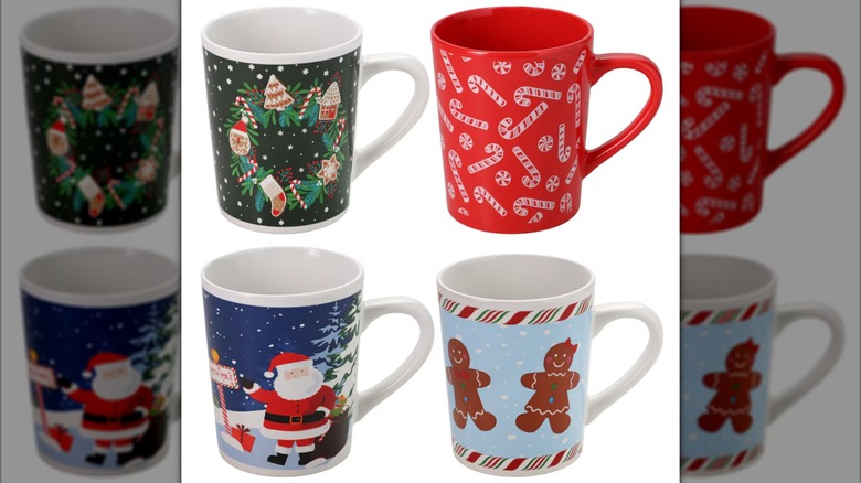 Four coffee mugs with Christmas-themed designs on them