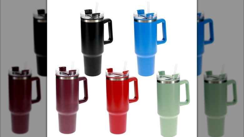Five plastic tumblers in assorted colors, with lids, handles, and straws