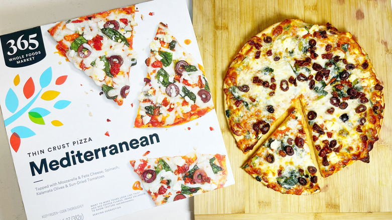 The Mediterranean pizza with a slice cut next to the box