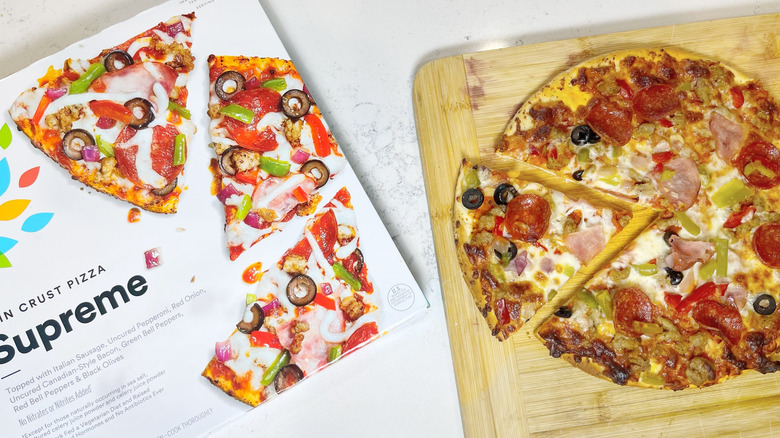 The supreme pizza box next to the baked pie