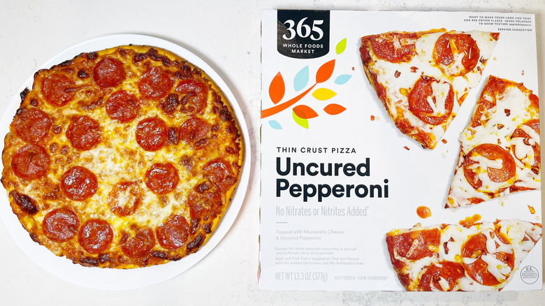 The pepperoni pizza from Whole Foods on a plate next to the box