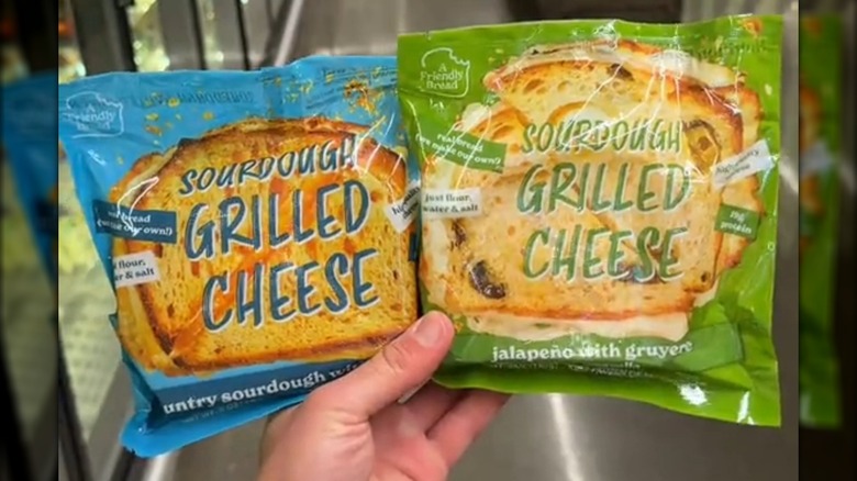 2 individually wrapped frozen sourdough grilled cheeses, one in blue packaging and another in green