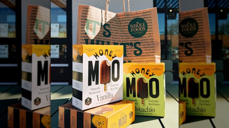 Honey Moo ice cream boxes posed with a Whole Foods shopping bag