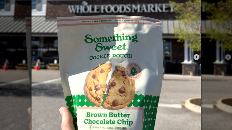A bag of Something Sweet Brown Butter Chocolate Chip Cookie Dough outside of a Whole Foods