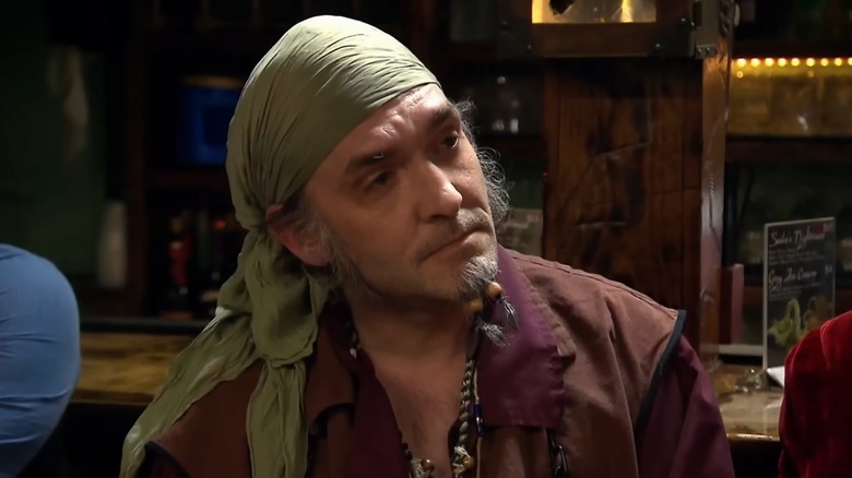 A man is pictured in a pirate costume, looking off-camera