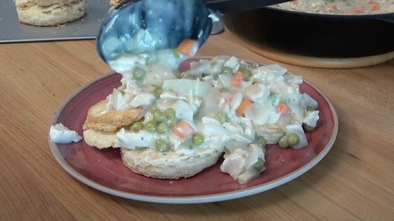 Creamed chicken is ladled over biscuits