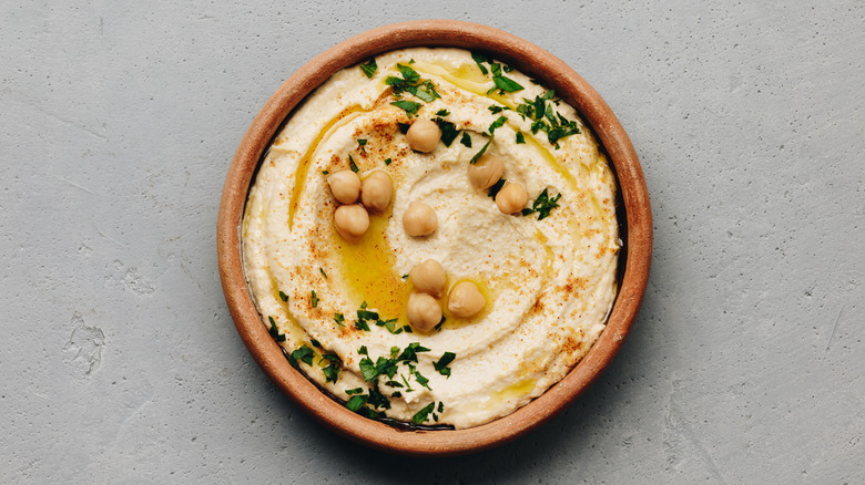 bowl of hummus with side of chickpeas