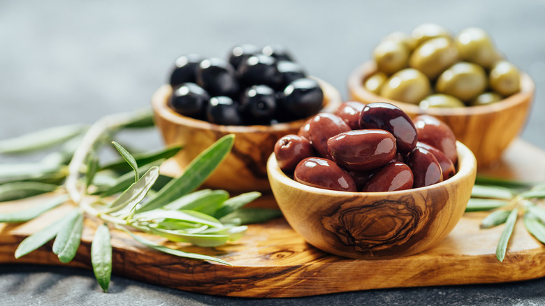 black, Kalamata, and green olives in bowls
