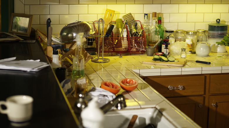 Cluttered, L-shaped kitchen countertop
