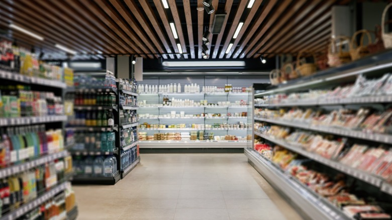 blurred supermarket aisles with dairy aisle in focus