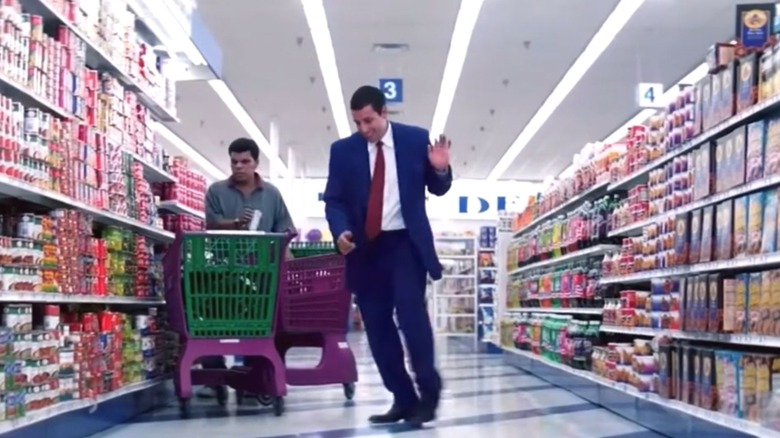 Adam Sandler dancing in a supermarket aisle