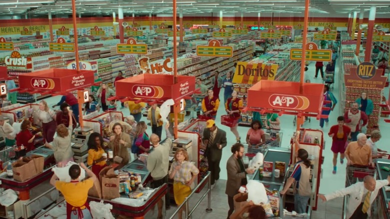 Wide shot of supermarket with people dancing in checkout line