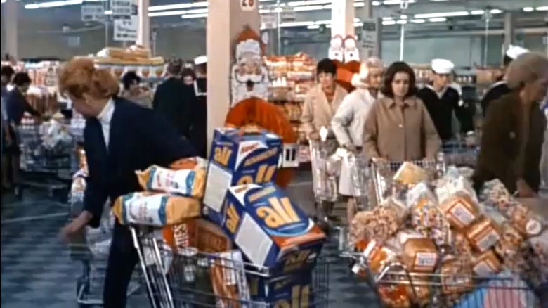 Lucille Ball pushing multiple shopping carts