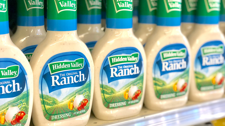 A row of Hidden Valley Original Ranch dressing bottles on a grocery store shelf