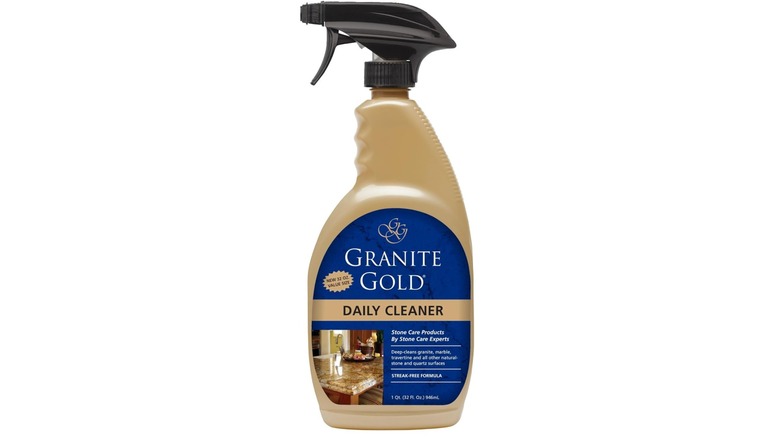 Gold bottle of Granite Gold Daily Cleaner with blue label and white background