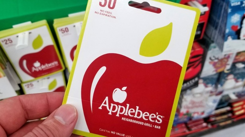 person holding an applebee's gift voucher