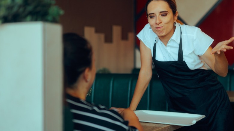 server gesticulating rudely at customer