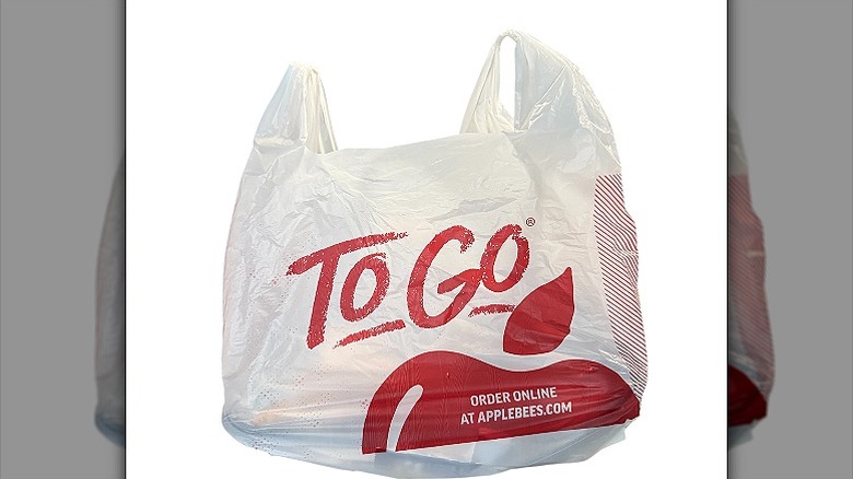 a plastic Applebee's delivery bag