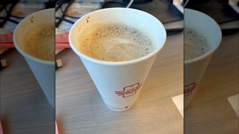 A Dunkin' coffee not filled to the rim, seen from overhead