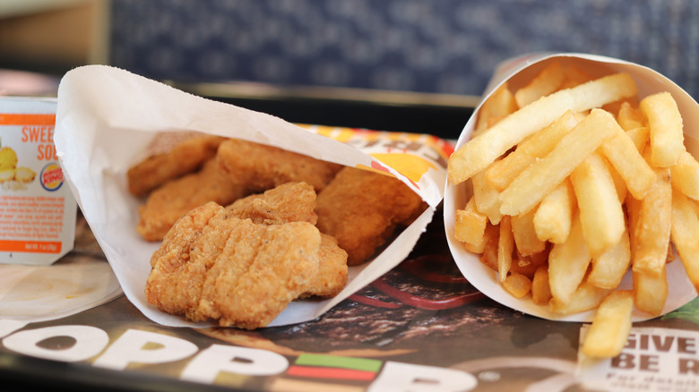 A serving of Burger King chicken nuggets, next to a serving of fries