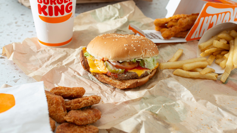 A selection of Burger King food, including a burger, chicken nuggets, fries, Chicken Fries, and a drink