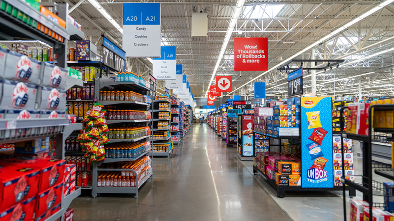 Long, empty Walmart aisle with no floor associates visible