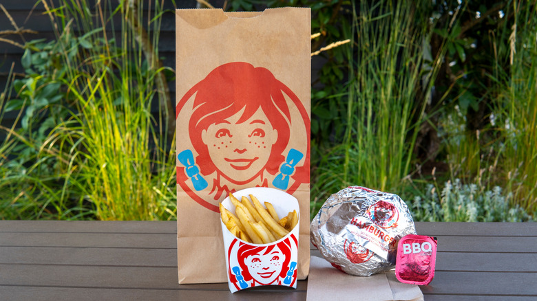 A Wendy's combo meal is shown on a picnic table.
