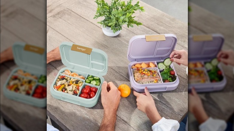 Hands holding Bentgo modern lunch boxes