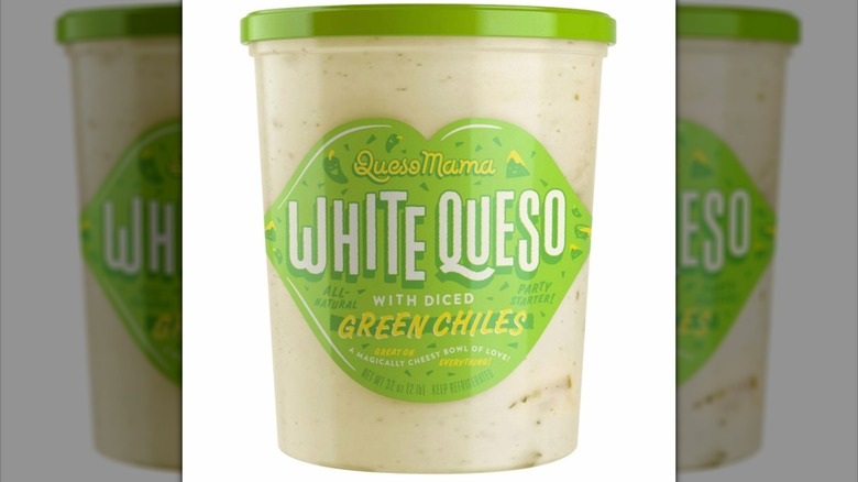 A clear container of Queso Mama White Queso with green label and lid