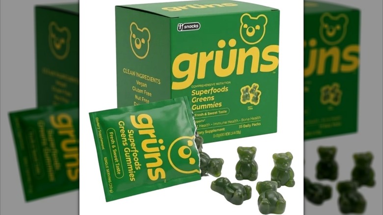 A green box of Grüns Adult Greens Gummies with yellow text, showing the green gummy bears