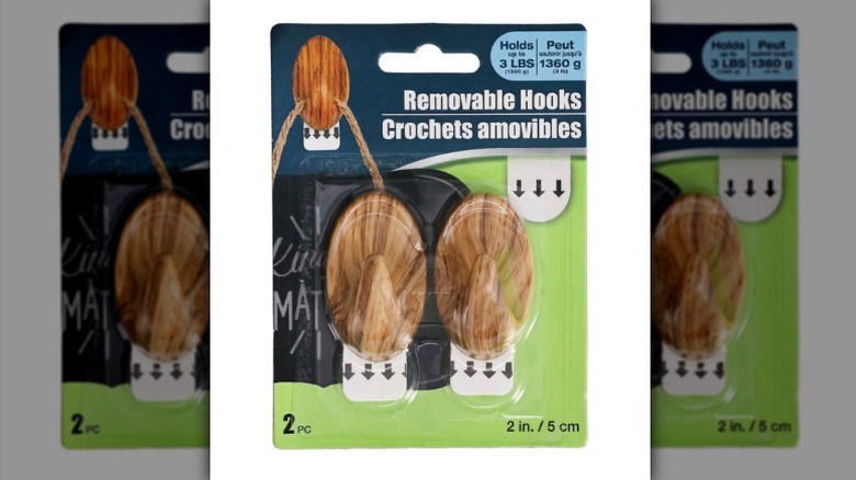 Wooden looking plastic wall hooks on white background