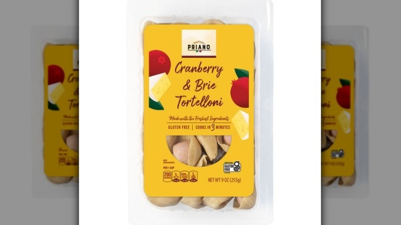 Container of cranberry brie tortelloni on white background