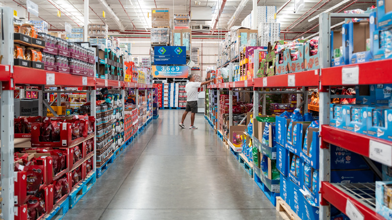 Man picking out item from Sam's Club aisle