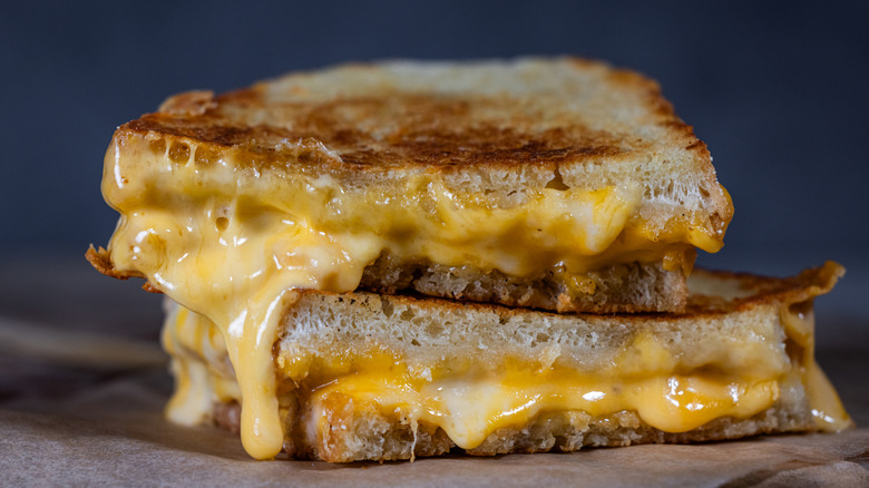 Two halves of a grilled cheese sandwich on a table