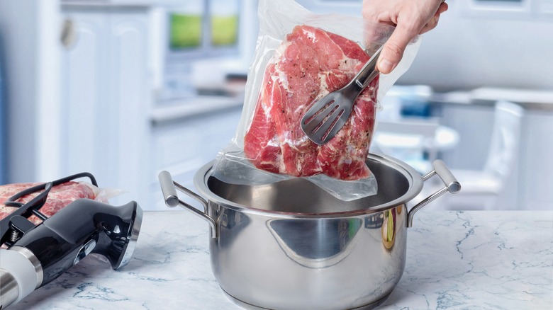 sous vide steak going into pot