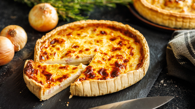 Slice from a quiche Lorraine on countertop