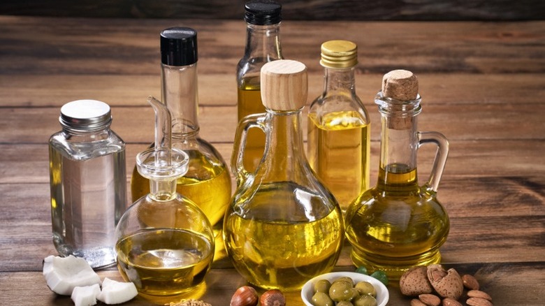 A variety of cooking oils in glass jars and bottles