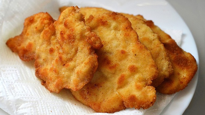 Fried, breaded cutlets draining on a paper towel
